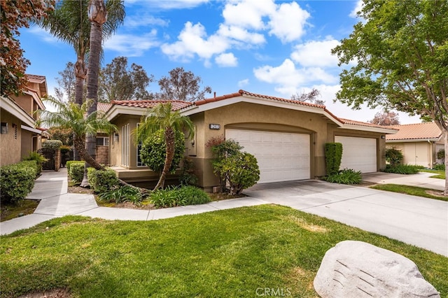 mediterranean / spanish-style home featuring a garage, stucco siding, a tile roof, concrete driveway, and a front lawn