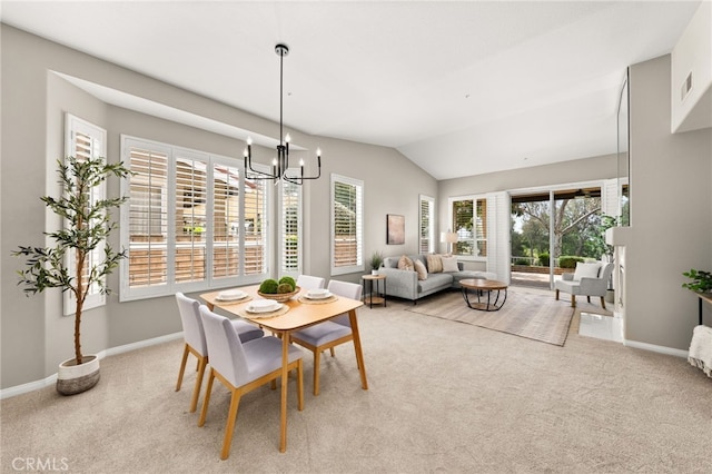 dining room with lofted ceiling, visible vents, an inviting chandelier, light carpet, and baseboards