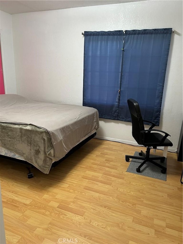 bedroom featuring light wood finished floors