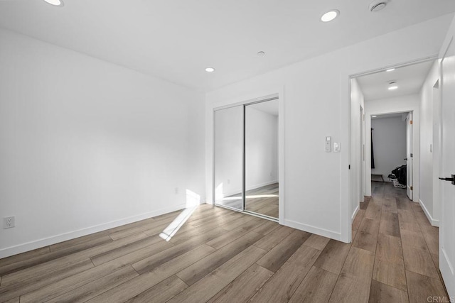 1990 Harrison Ave, San Diego, CA 92113 - unfurnished bedroom featuring a closet, recessed lighting, and wood finished floors