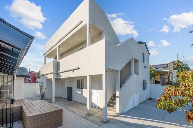 1990 Harrison Ave, San Diego, CA 92113 - view of side of home with a patio area, stucco siding, and fence