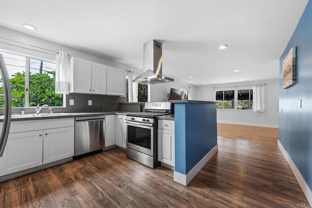 1990 Harrison Ave, San Diego, CA 92113 - kitchen with recessed lighting, dark wood finished floors, a peninsula, island range hood, and stainless steel appliances