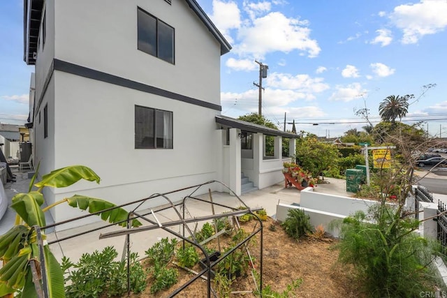 1990 Harrison Ave, San Diego, CA 92113 - back of property featuring a patio area, stucco siding, and fence