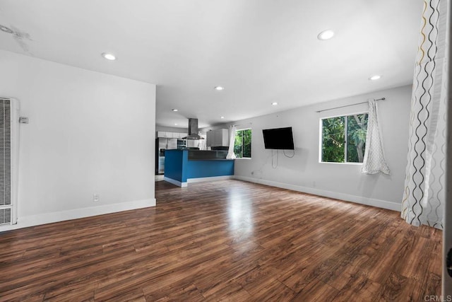 1990 Harrison Ave, San Diego, CA 92113 - unfurnished living room featuring baseboards, a heating unit, recessed lighting, and dark wood-type flooring