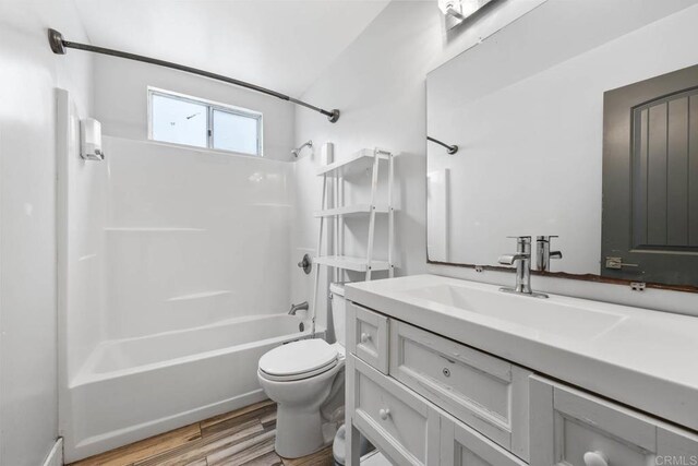 1990 Harrison Ave, San Diego, CA 92113 - full bath featuring toilet, washtub / shower combination, vanity, and wood finished floors