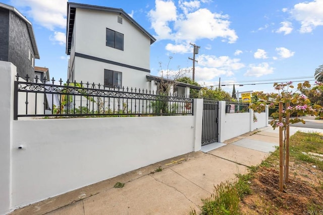 1990 Harrison Ave, San Diego, CA 92113 - view of home's exterior featuring a fenced front yard, stucco siding, and a gate