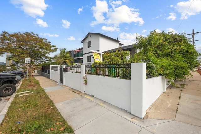 1990 Harrison Ave, San Diego, CA 92113 - view of side of home with a fenced front yard and stucco siding