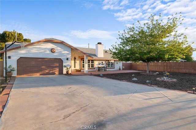 21089 Ottawa Rd, Apple Valley, CA 92308 - ranch-style house with an attached garage, concrete driveway, stucco siding, and fence