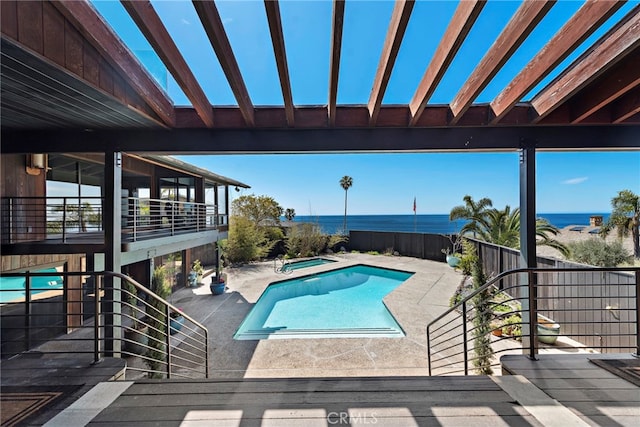 view of pool featuring a water view, a patio area, an in ground hot tub, and a fenced in pool