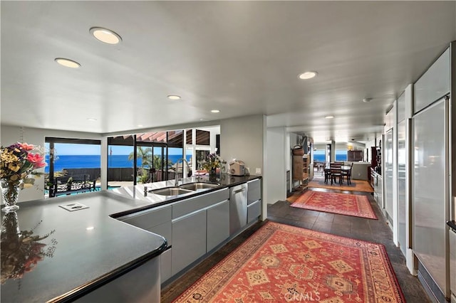 kitchen with a sink, recessed lighting, a wealth of natural light, and dishwasher