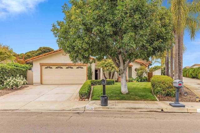 view of property hidden behind natural elements featuring an attached garage, a tile roof, concrete driveway, stucco siding, and a front lawn
