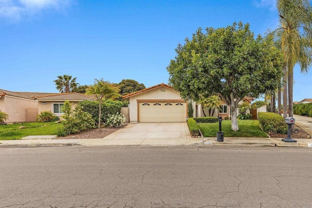 view of front of house with an attached garage, stucco siding, a tile roof, a front yard, and driveway