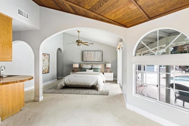 bedroom with arched walkways, light colored carpet, visible vents, and wooden ceiling