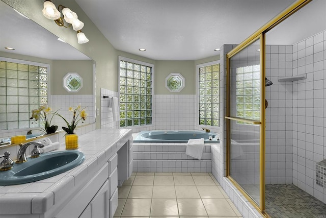 full bathroom with a garden tub, a tile shower, tile patterned floors, vanity, and recessed lighting