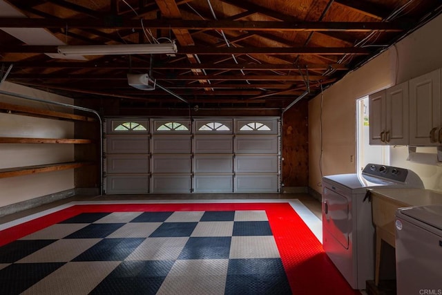 garage featuring washer and clothes dryer and a garage door opener