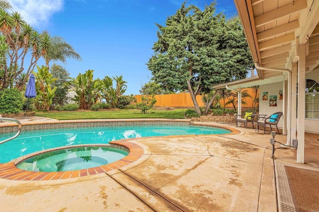 view of pool with a patio area, a pool with connected hot tub, and a fenced backyard