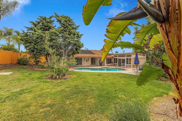 view of yard with a patio area, a fenced in pool, and a fenced backyard