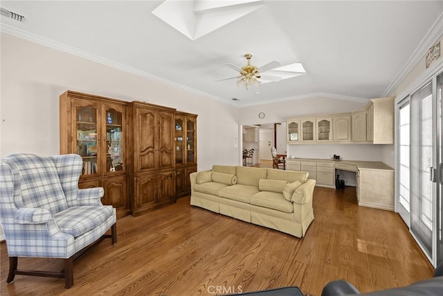 15723 La Belle St, Hacienda Heights, CA 91745 - living room with crown molding, lofted ceiling with skylight, a ceiling fan, and wood finished floors