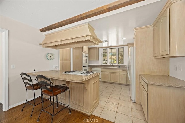 15723 La Belle St, Hacienda Heights, CA 91745 - kitchen with a sink, a peninsula, white appliances, a breakfast bar area, and light brown cabinets