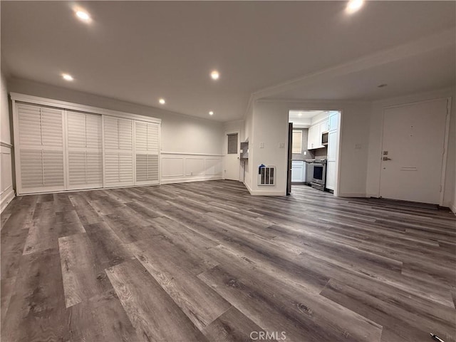 22723 Maple Ave, Torrance, CA 90505 - unfurnished living room featuring a decorative wall, dark wood finished floors, recessed lighting, wainscoting, and crown molding