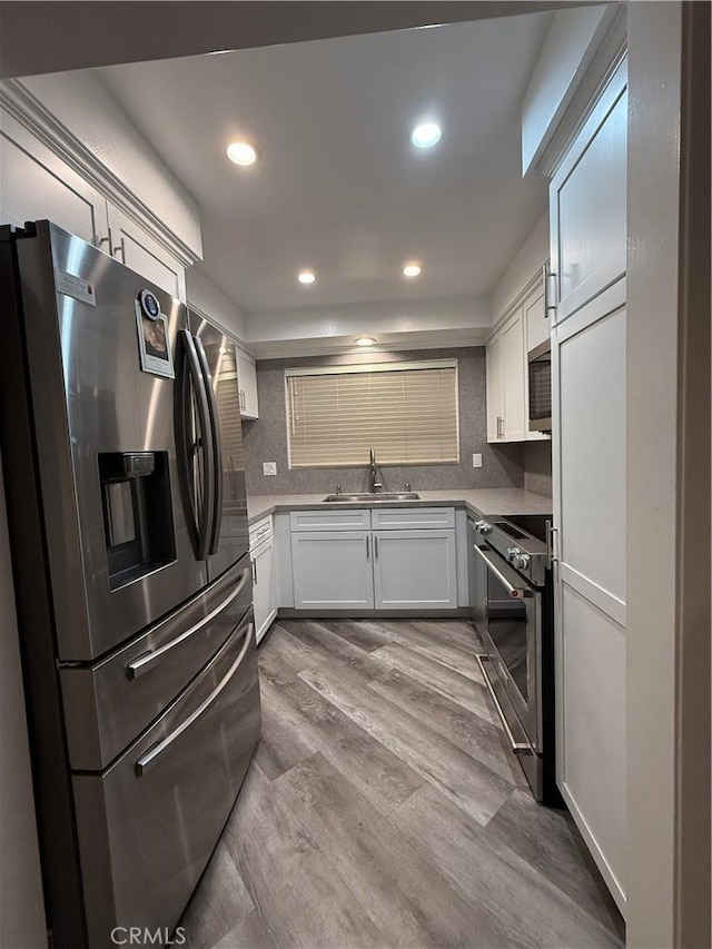 22723 Maple Ave, Torrance, CA 90505 - kitchen with stainless steel appliances, recessed lighting, white cabinets, and wood finished floors