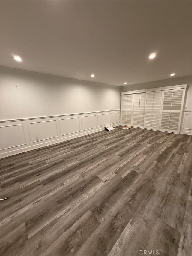22723 Maple Ave, Torrance, CA 90505 - empty room with a decorative wall, recessed lighting, dark wood-style flooring, and wainscoting