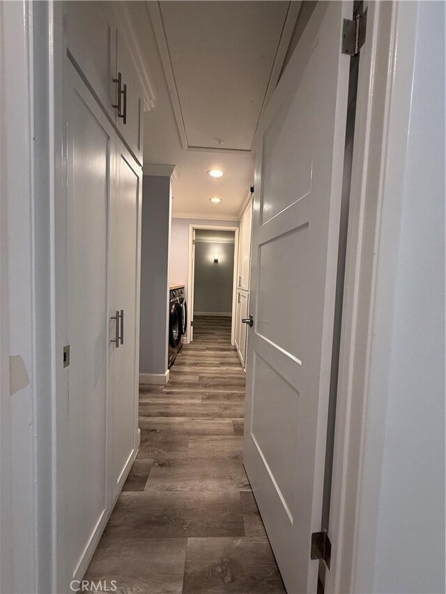 hallway featuring recessed lighting, attic access, baseboards, crown molding, and dark wood-type flooring