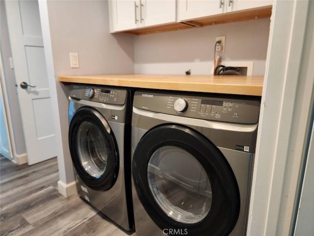 22723 Maple Ave, Torrance, CA 90505 - washroom featuring washer and clothes dryer, cabinet space, and wood finished floors