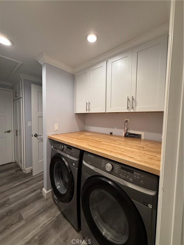 clothes washing area with cabinet space, ornamental molding, recessed lighting, separate washer and dryer, and dark wood-style flooring