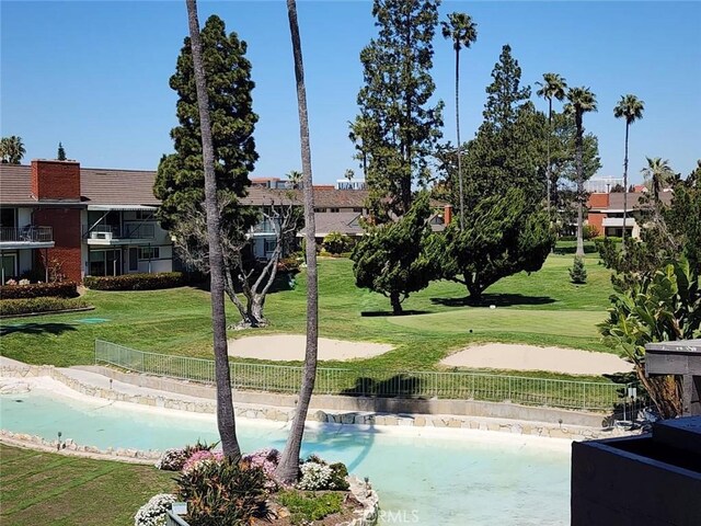 view of swimming pool featuring a yard, a fenced in pool, and a fenced backyard