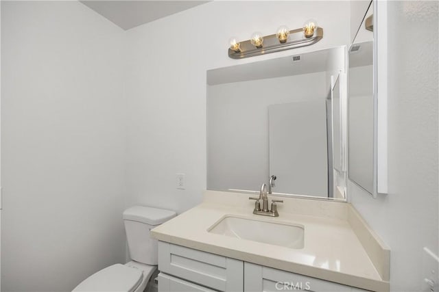 bathroom with toilet and vanity