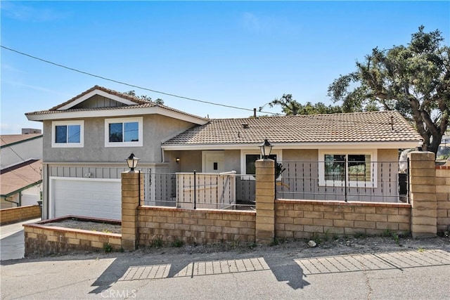 tri-level home with stucco siding, a fenced front yard, an attached garage, and a tile roof
