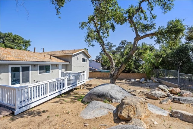 view of yard with a wooden deck and fence