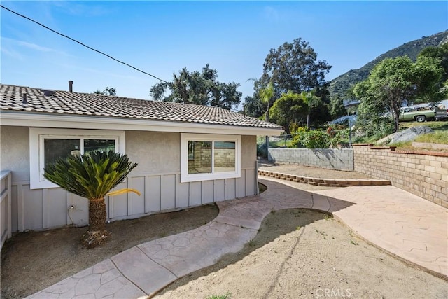 33340 Gisborne Way, Lake Elsinore, CA 92530 - view of side of property featuring a mountain view, a tile roof, a patio, and stucco siding