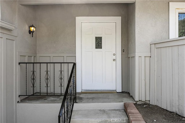 property entrance featuring stucco siding