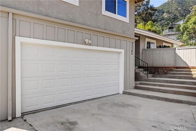 garage featuring concrete driveway