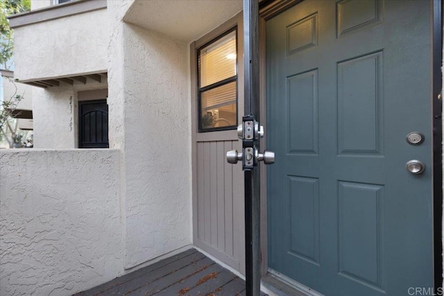 entrance to property with stucco siding