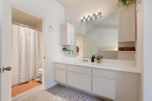 bathroom with toilet and vanity