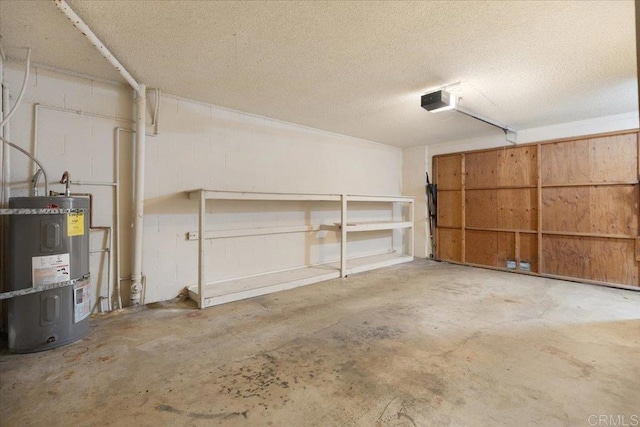 garage with electric water heater, a garage door opener, and concrete block wall