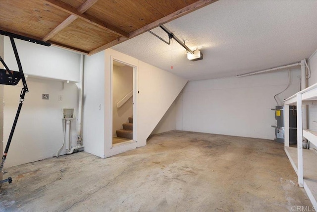 garage with strapped water heater and a garage door opener