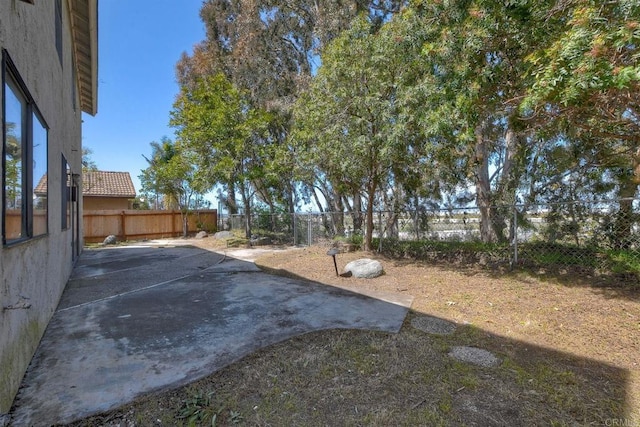 view of yard featuring a patio area and a fenced backyard