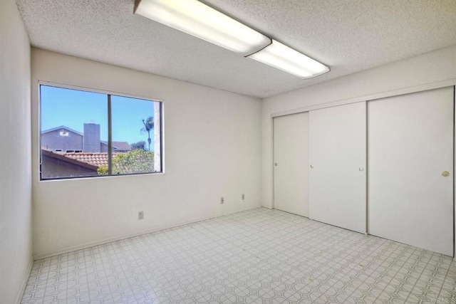 unfurnished bedroom with a closet and a textured ceiling