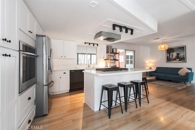 1145 Apache, Topanga, CA 90290 - kitchen with appliances with stainless steel finishes, a sink, a kitchen bar, and light wood-type flooring