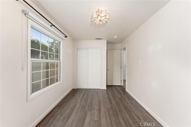 6338 Court Ave, Whittier, CA 90601 - unfurnished bedroom with a closet, wood finished floors, visible vents, and baseboards