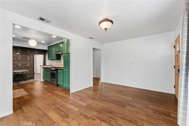 6338 Court Ave, Whittier, CA 90601 - unfurnished living room featuring baseboards, visible vents, and wood finished floors