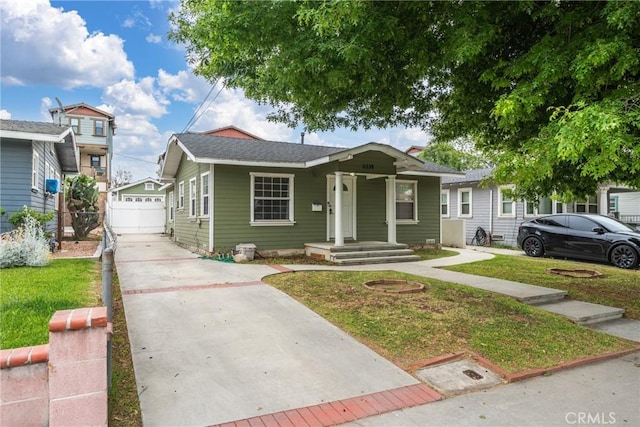 6338 Court Ave, Whittier, CA 90601 - bungalow-style home with a front yard, fence, and a detached garage