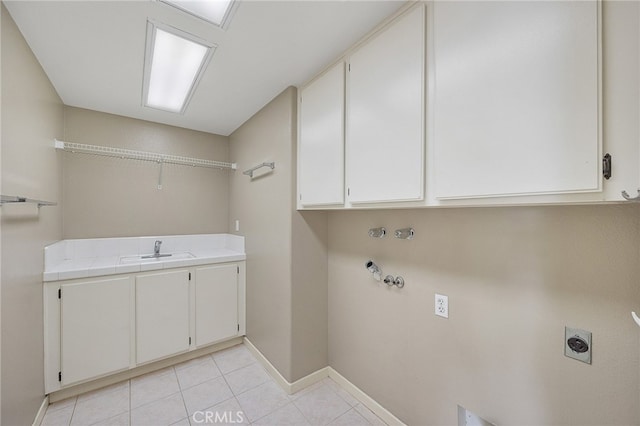 laundry room featuring light tile patterned floors, a sink, cabinet space, hookup for an electric dryer, and gas dryer hookup