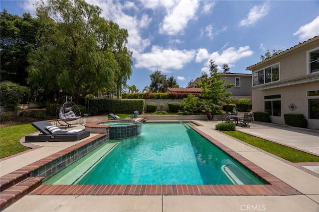 view of swimming pool with a patio area, a pool with connected hot tub, and fence