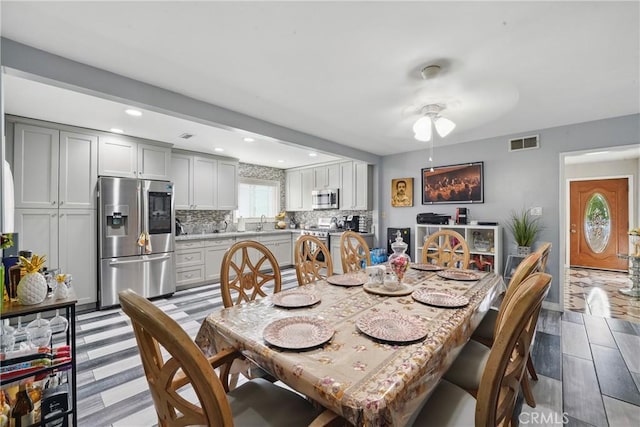 dining area with light wood-style flooring, visible vents, baseboards, ceiling fan, and recessed lighting