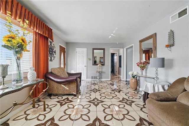 living room with baseboards and visible vents